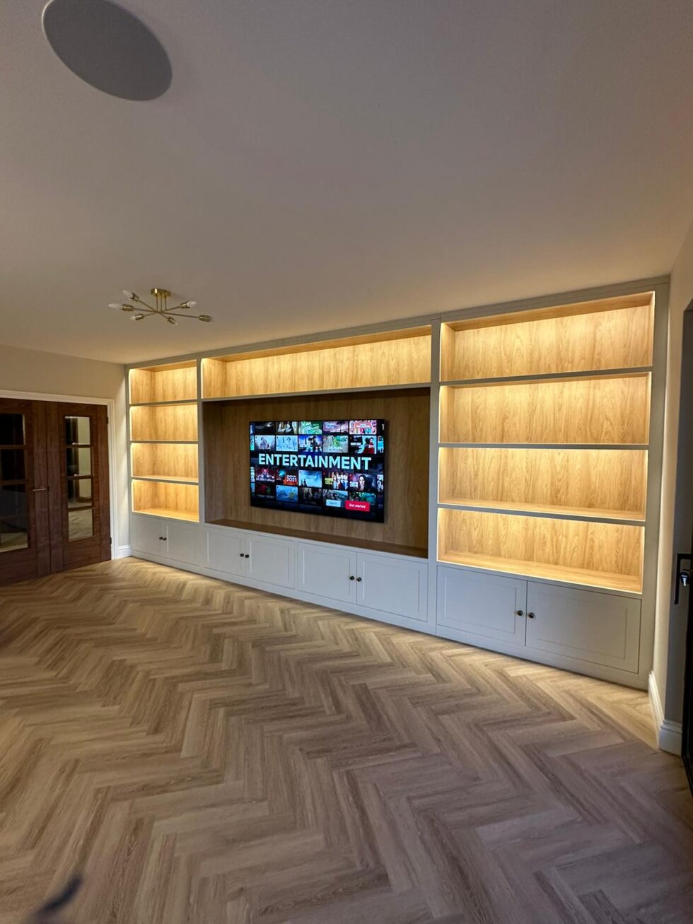 Contemporary fitted media unit with concealed storage
